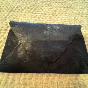 BCBG leather black clutch. Lightweight, fashionable and in perfect conditions.
